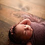 Palmer is registered to the contest to win money with this photo: newborn, baby, sleeping, infant, purple_blanket, headband, flower_headband, wooden_floor, peaceful, wrapped, soft_texture, portrait, closeup, cute, resting, arms_up, indoor, warm_light, skin, peaceful_expression