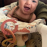 Palmer joined the competition — help win amazing prizes! baby, smiling, infant, face, toy, plush_toy, baby_seat, colorful, happy, indoors, child, person, cute, soft_toy, rings, clothing, head, seat, play, joyful