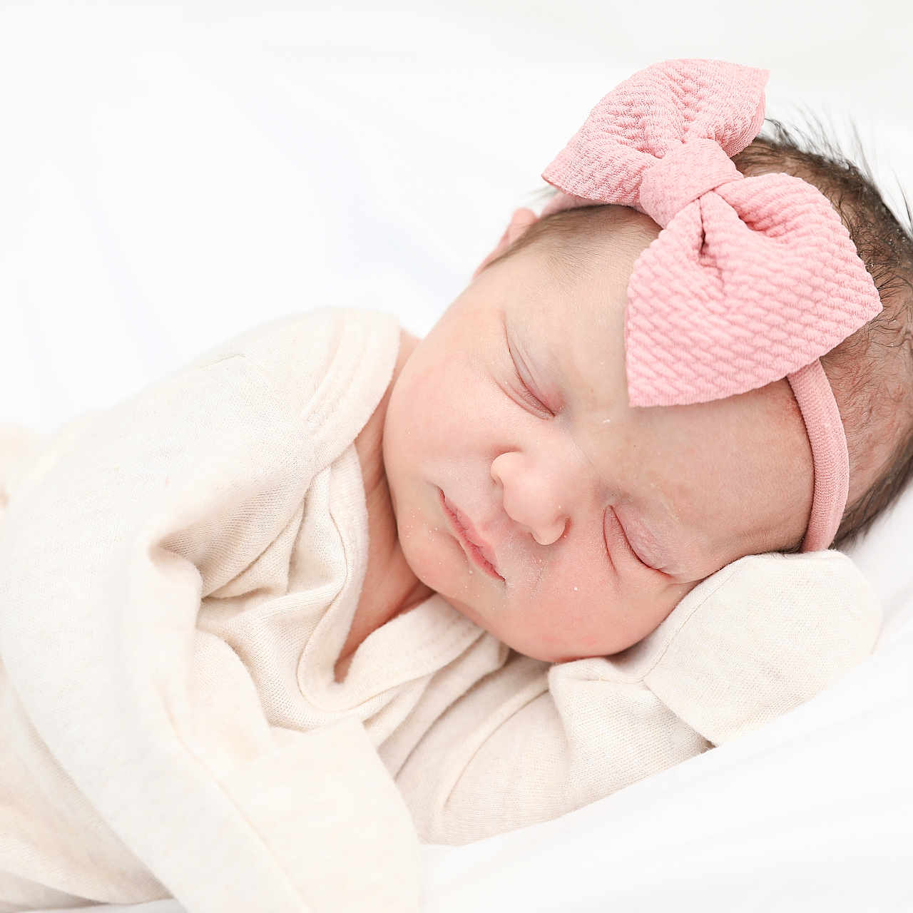 Aurora is registered to the contest to win money with this photo: accessories, baby, bed, blanket, bonnet, clothing, face, furniture, glove, happy, hat, head, headband, newborn, person, photography, portrait, sleeping, smile