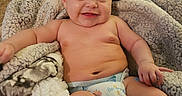 Irie joined the competition — help win amazing prizes! baby, smiling, blanket, diaper, infant, happy, cute, cozy, carpet, sofa, child, skin, toddler, indoors, portrait, relaxing, comfort, warm, plush, couch