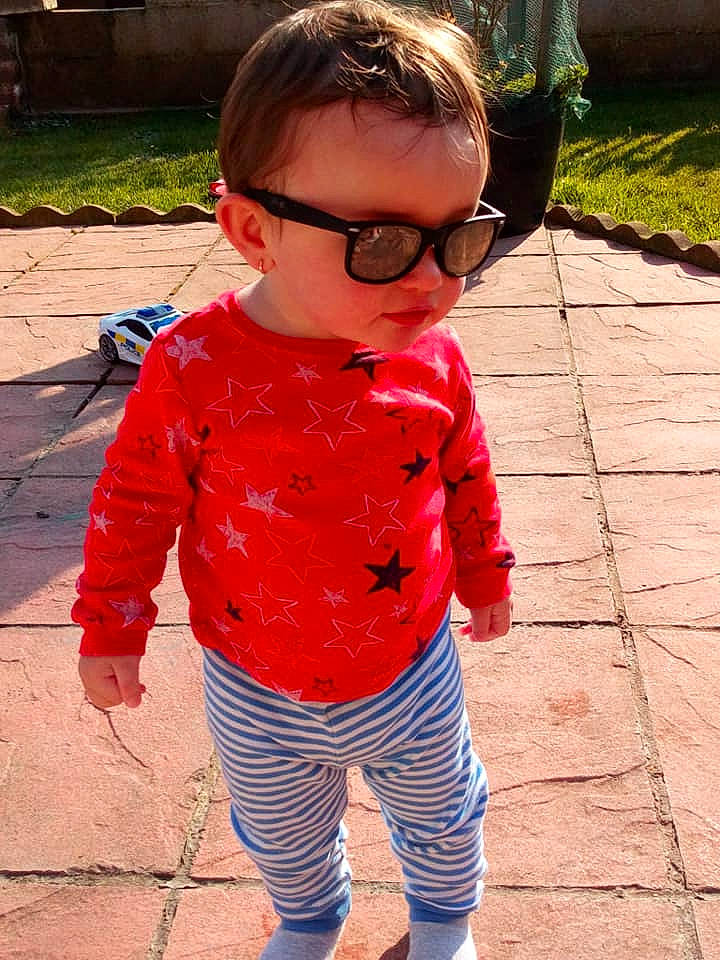 Noah is registered to the contest to win money with this photo: child, clothing, cool, eyewear, glasses, outerwear, person, pink, play, sleeve, sunglasses, toddler