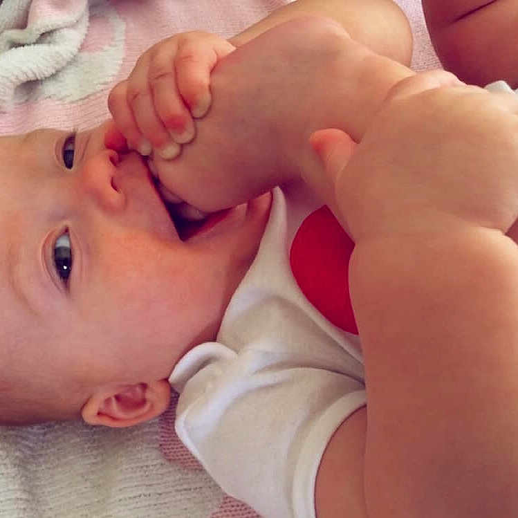 Bridget is registered to the contest to win money with this photo: arm, baby, beauty, cheek, child, chin, close_up, eye, face, finger, hand, head, leg, lip, mouth, muscle, nose, organ, skin, toddler