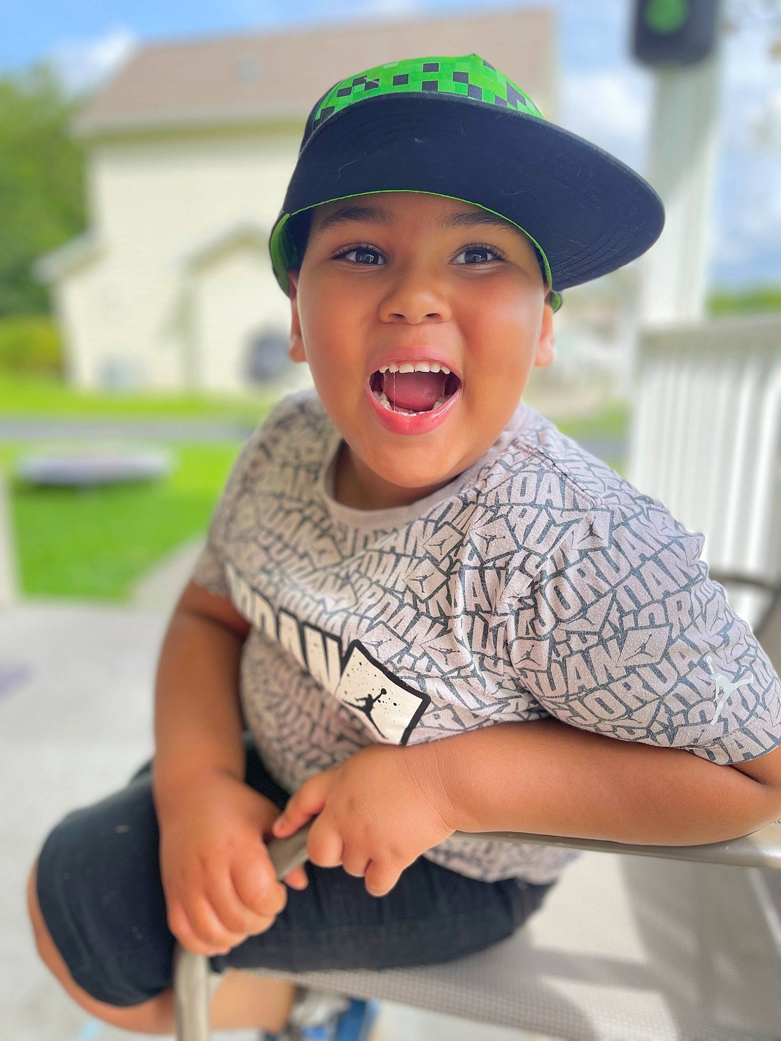 Desmond joined the competition — help win amazing prizes! cap, child, electric_blue, fashion_accessory, fun, gesture, happy, headgear, headwear, jewellery, laugh, leisure, person, recreation, sitting, sky, sleeve, smile, t_shirt, thumb