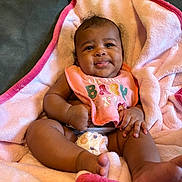 Samyra joined the competition — help win amazing prizes! baby, infant, smiling, blanket, pink, bib, diaper, couch, happy, cute, child, skin, hand, foot, face, expression, indoors, soft, relaxed, comfort