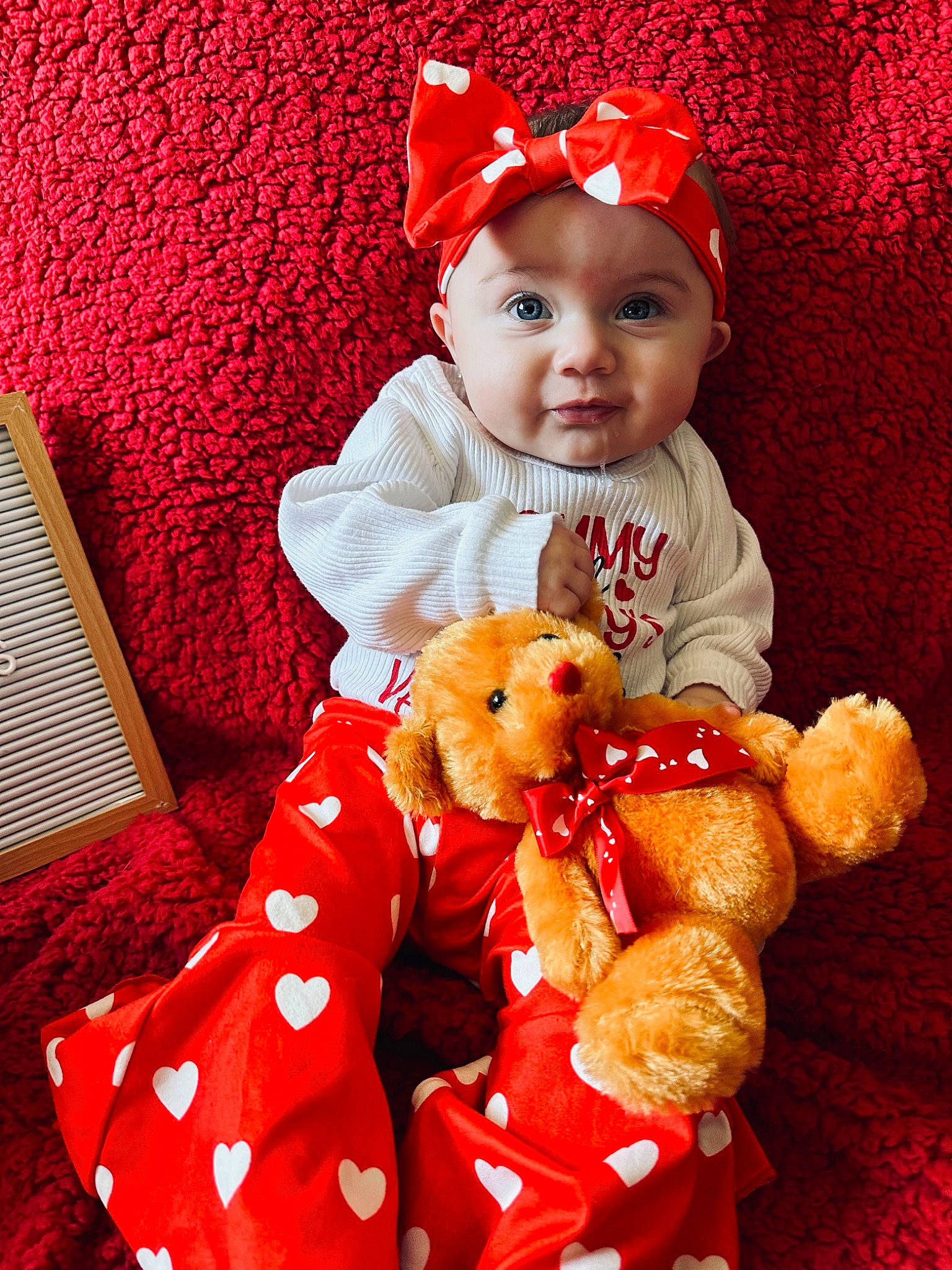 Violet joined the competition — help win amazing prizes! baby, baby_toddler_clothing, cap, child, costume_hat, event, fur, happy, hat, head, headwear, holiday, human_body, person, plush, red, sleeve, stuffed_toy, teddy_bear, textile