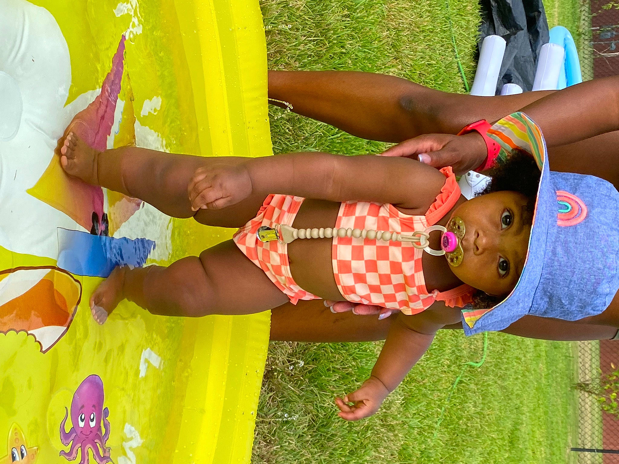 Journee is registered to the contest to win money with this photo: abdomen, child, fun, grass, green, happy, headwear, human_leg, knee, leg, leisure, people, people_in_nature, person, recreation, sandal, shorts, summer, textile, thigh