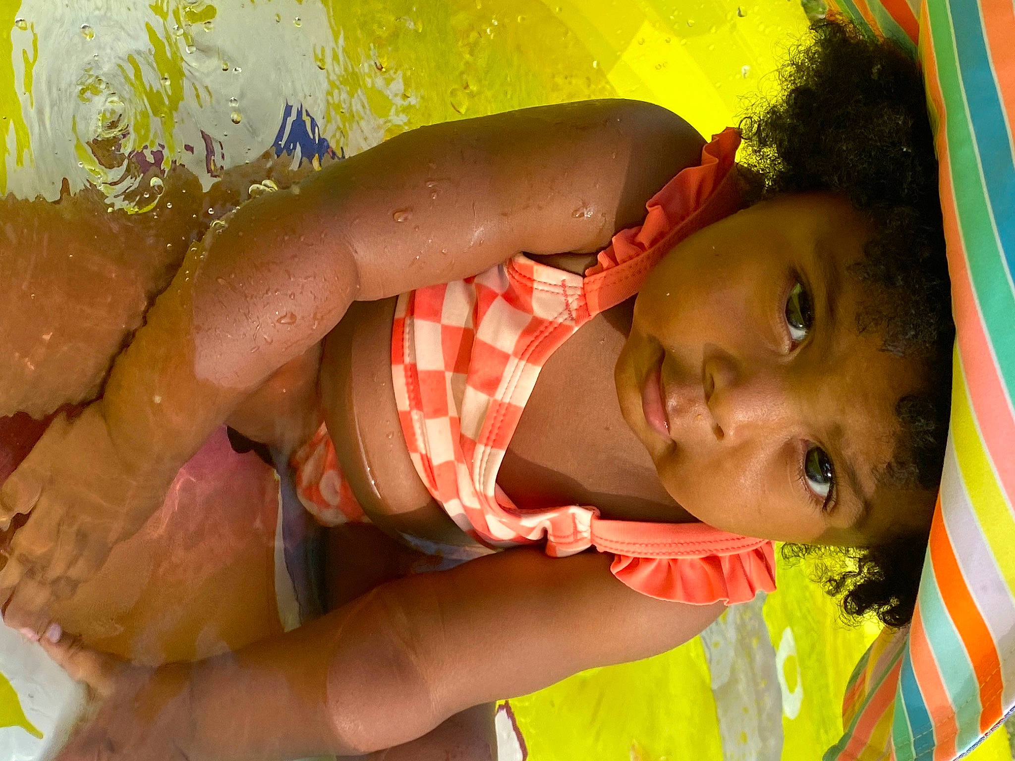 Journee is registered to the contest to win money with this photo: baby, bathing, black_hair, chest, child, close_up, dress, fun, hand, happy, human_body, leisure, mouth, people_in_nature, person, skin, summer, toddler, tree, water