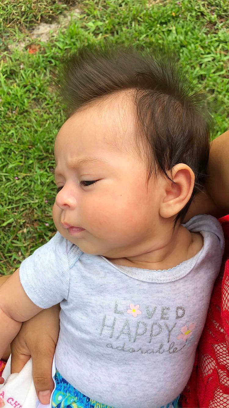 Natasha is registered to the contest to win money with this photo: baby, baby_toddler_clothing, cheek, child, chin, ear, eye, eyebrow, eyelash, forehead, grass, green, happy, iris, lip, neck, nose, person, skin, sleeve