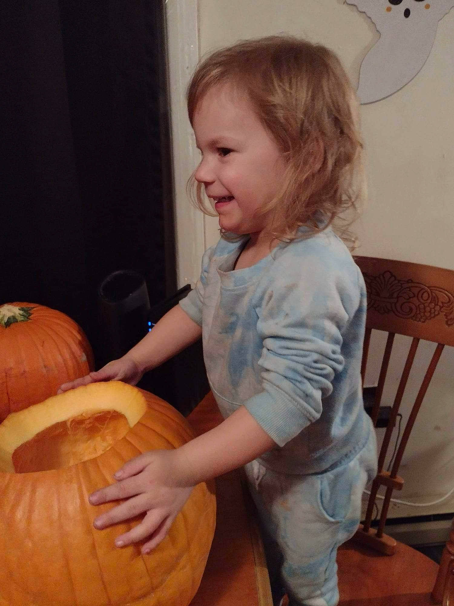 Ayva joined the competition — help win amazing prizes! baby_toddler_clothing, blond, calabaza, chair, child, comfort, cucurbita, flooring, gourd, hair, natural_foods, person, plant, produce, pumpkin, smile, squash, toddler, vegetable, winter_squash