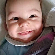 Samuel participe au concours pour gagner de l'argent avec cette photo : baby, infant, smiling, face, eyes, tongue, blanket, towel, swaddle, cozy, portrait, closeup, happy, cheeks, newborn, lying_down, clothing, button, fabric, indoor