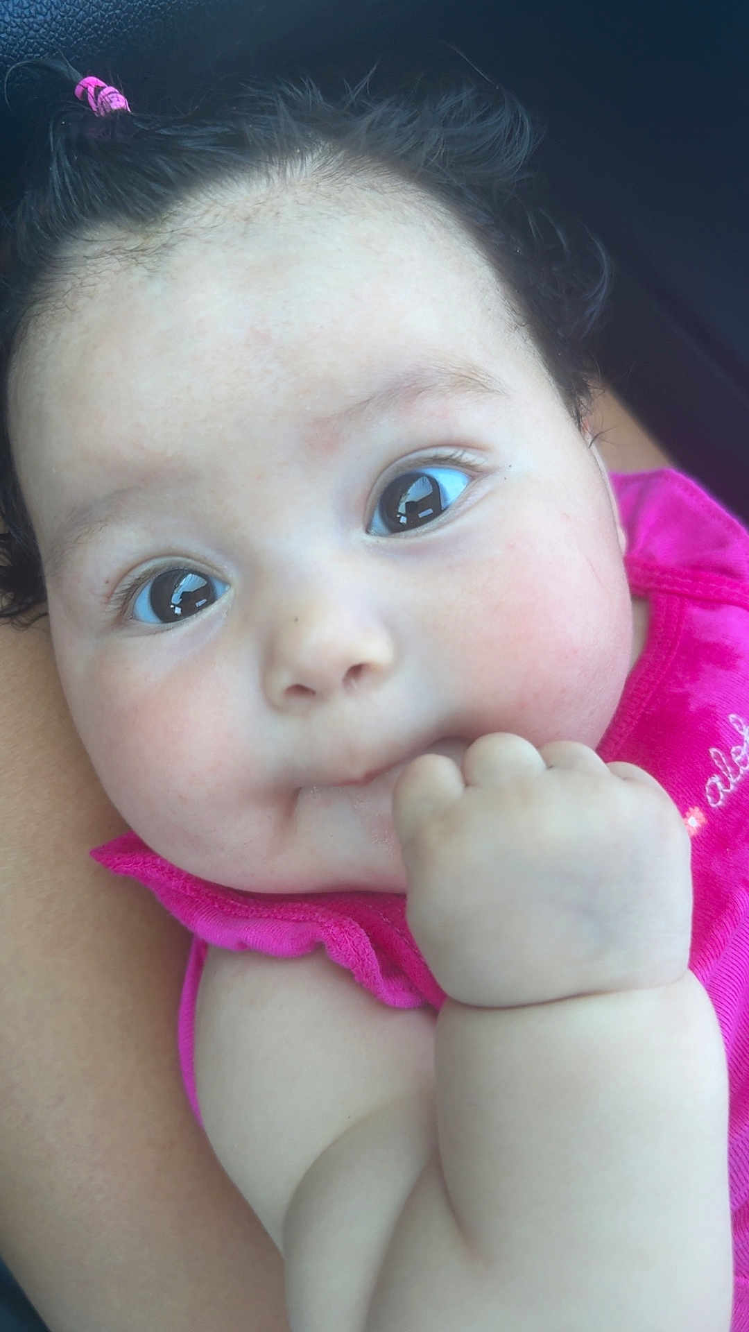 Samara is registered to the contest to win money with this photo: baby, infant, closeup, face, hand, pink_clothing, cute, child, skin, eyelashes, hair, expression, portrait, person, young, adorable, cheeks, curiosity, mouth, fingertips