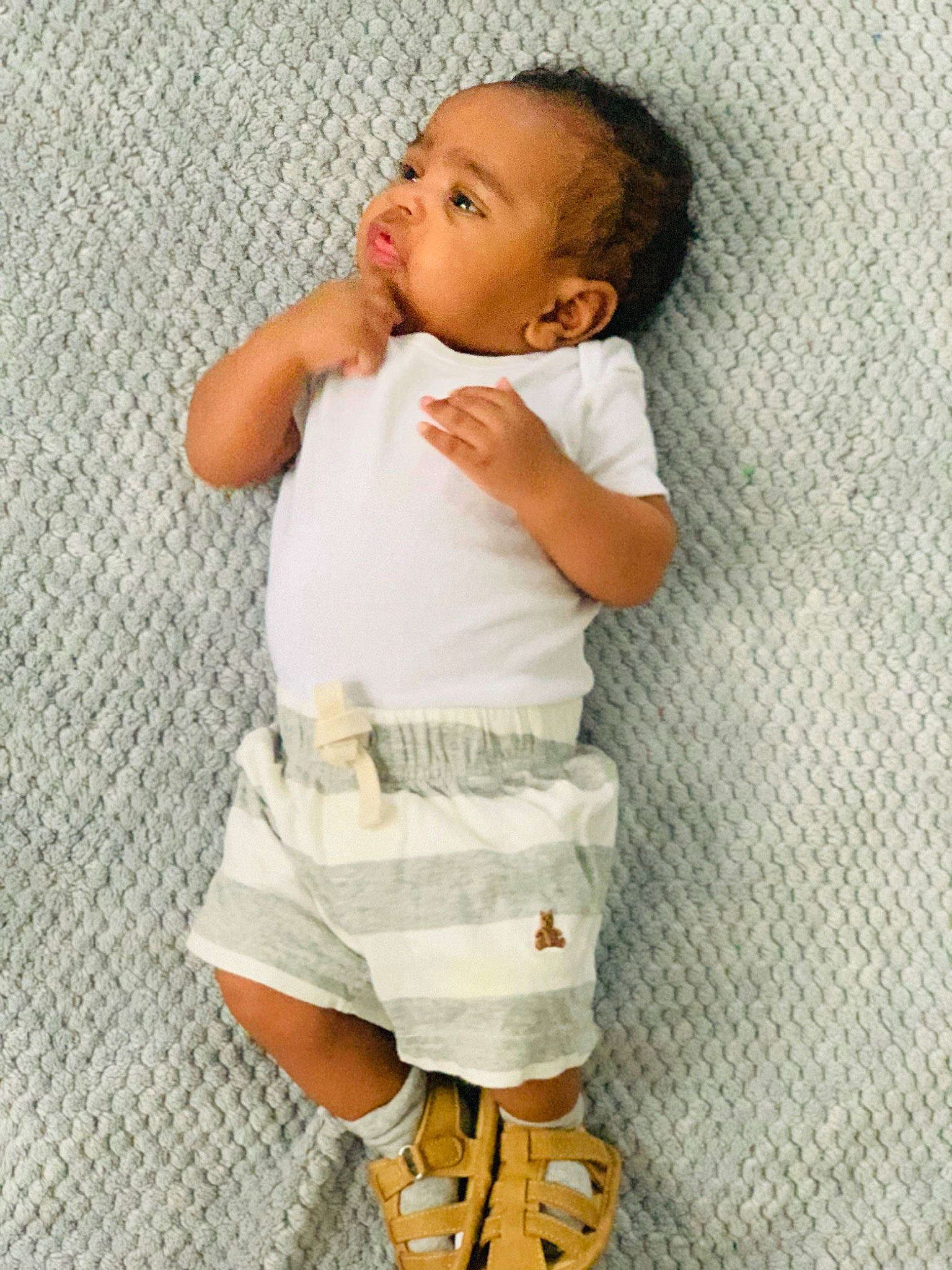 King joined the competition — help win amazing prizes! arm, baby, baby_toddler_clothing, child, comfort, elbow, face, gesture, hairstyle, hand, human_leg, knee, linens, pattern, person, skin, sleeve, sock, textile, thumb