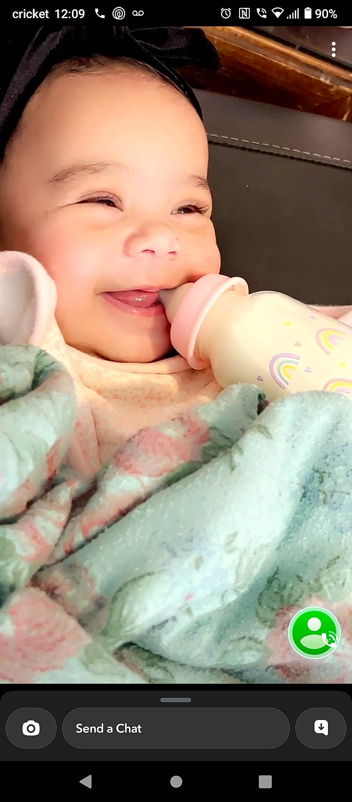 Khelani is registered to the contest to win money with this photo: baby, baby_toddler_clothing, cheek, chin, face, finger, gesture, green, hand, happy, joy, lip, mouth, muscle, nose, person, pink, skin, smile, textile