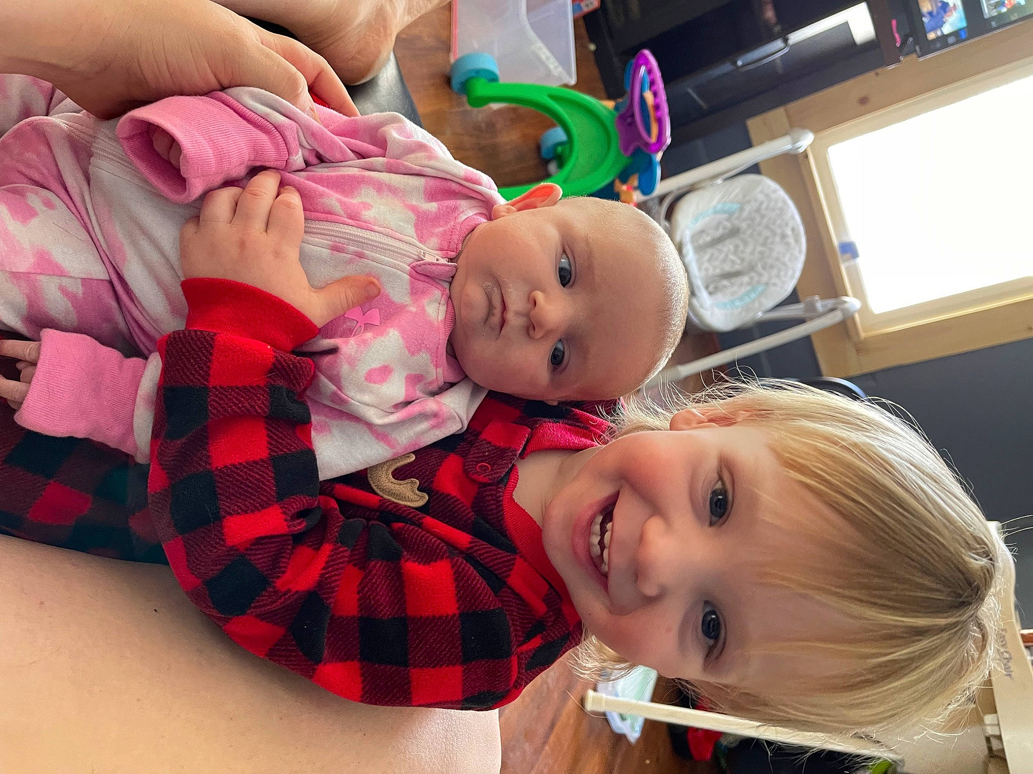 Zephyr is registered to the contest to win money with this photo: baby, child, christmas, event, fun, happy, hat, holiday, joy, lap, pattern, person, plaid, room, sitting, smile, tartan, toddler