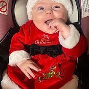 Nevaeh is registered to the contest to win money with this photo: baby, infant, christmas_outfit, santa_hat, red_clothing, white_fur_trim, car_seat, happy, smiling, cute, holiday, festive, child, portrait, indoors, clothing, seatbelt, white_tights, reindeer_embroidery, black_bow