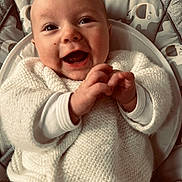 Charli participe au concours pour gagner de l'argent avec cette photo : baby, smiling, happy, clapping_hands, white_sweater, knitted, infant, cute, face, eyes, human, child, seat, cushion, elephant_pattern, indoor, portrait, joyful, closeup, cozy