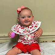 Ella-Grey joined the competition — help win amazing prizes! baby, child, smile, pink_bow, red_shorts, cherry_pattern, toy, purple_egg, sitting, blanket, happy, indoor, cute, portrait, infant, clothing, person, face, hands, feet