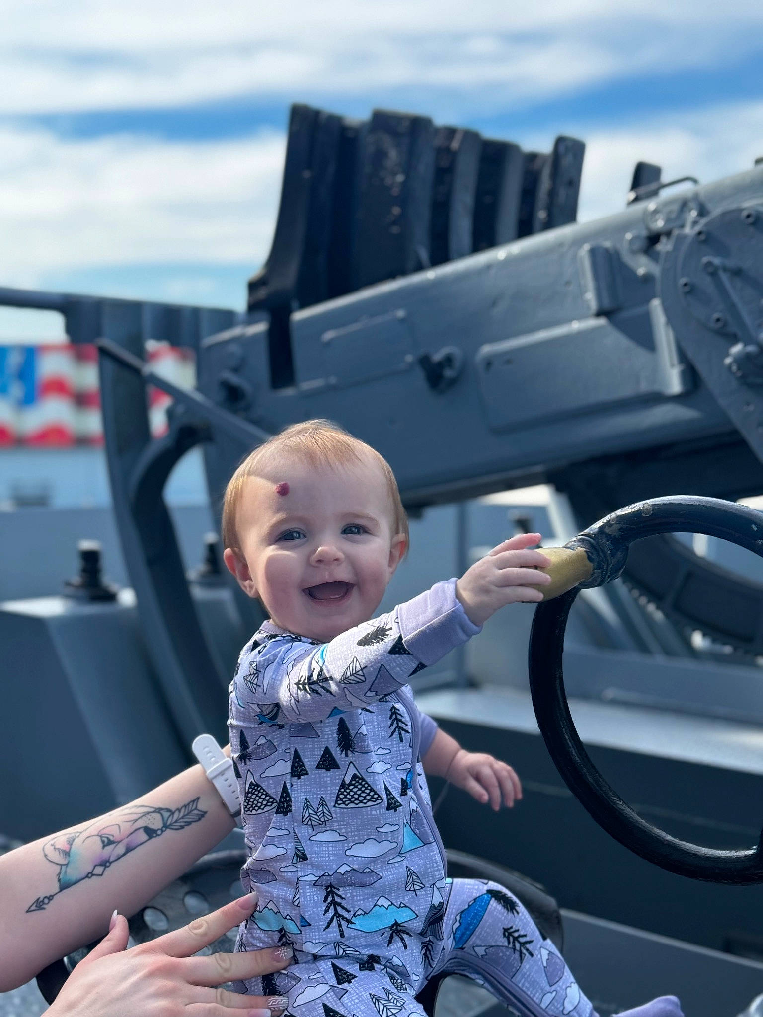 Kamryn is registered to the contest to win money with this photo: auto_part, automotive_design, automotive_exterior, automotive_tire, baby, baby_toddler_clothing, child, cloud, electric_blue, fun, happy, joy, leisure, motor_vehicle, person, recreation, sitting, sky, smile, toddler