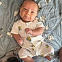 Thaddeus is registered to the contest to win money with this photo: baby, infant, smile, onesie, bee_pattern, blue_blanket, floral_pattern, dog, pet, lying_down, cute, happy, indoor, child, face, feet, hand, animal, sleeping, cozy