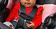 Delilah is registered to the contest to win money with this photo: baby, child, car_seat, headband, bow, red_shirt, minnie_mouse, pants, socks, seatbelt, safety, cute, infant, portrait, indoors, car, seat, child_safety, apparel, person