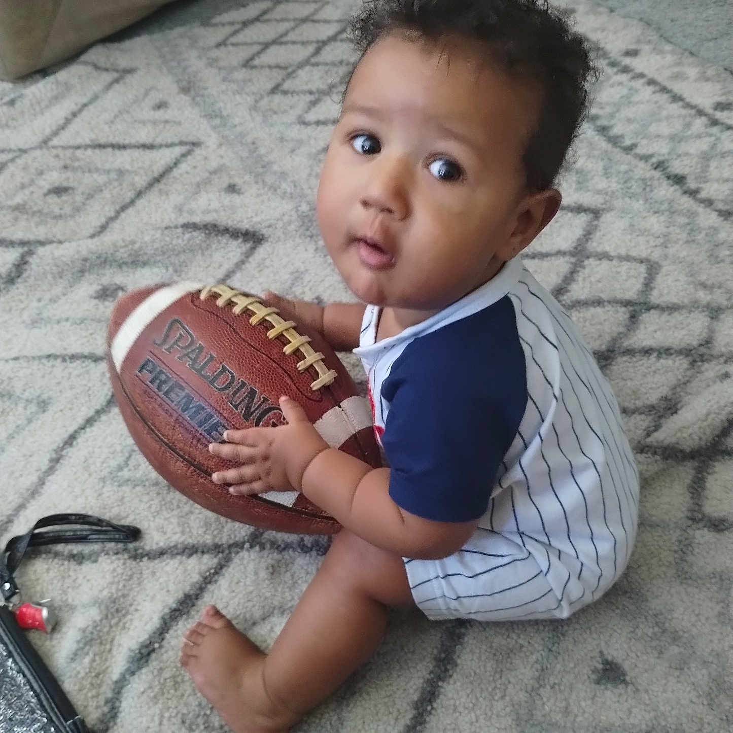 Izayah joined the competition — help win amazing prizes! americanfootball, americanfootballball, baby, ball, baseball, baseballglove, bodypart, clothing, face, finger, football, glove, head, people, person, photography, portrait, soccer, soccerball, sport
