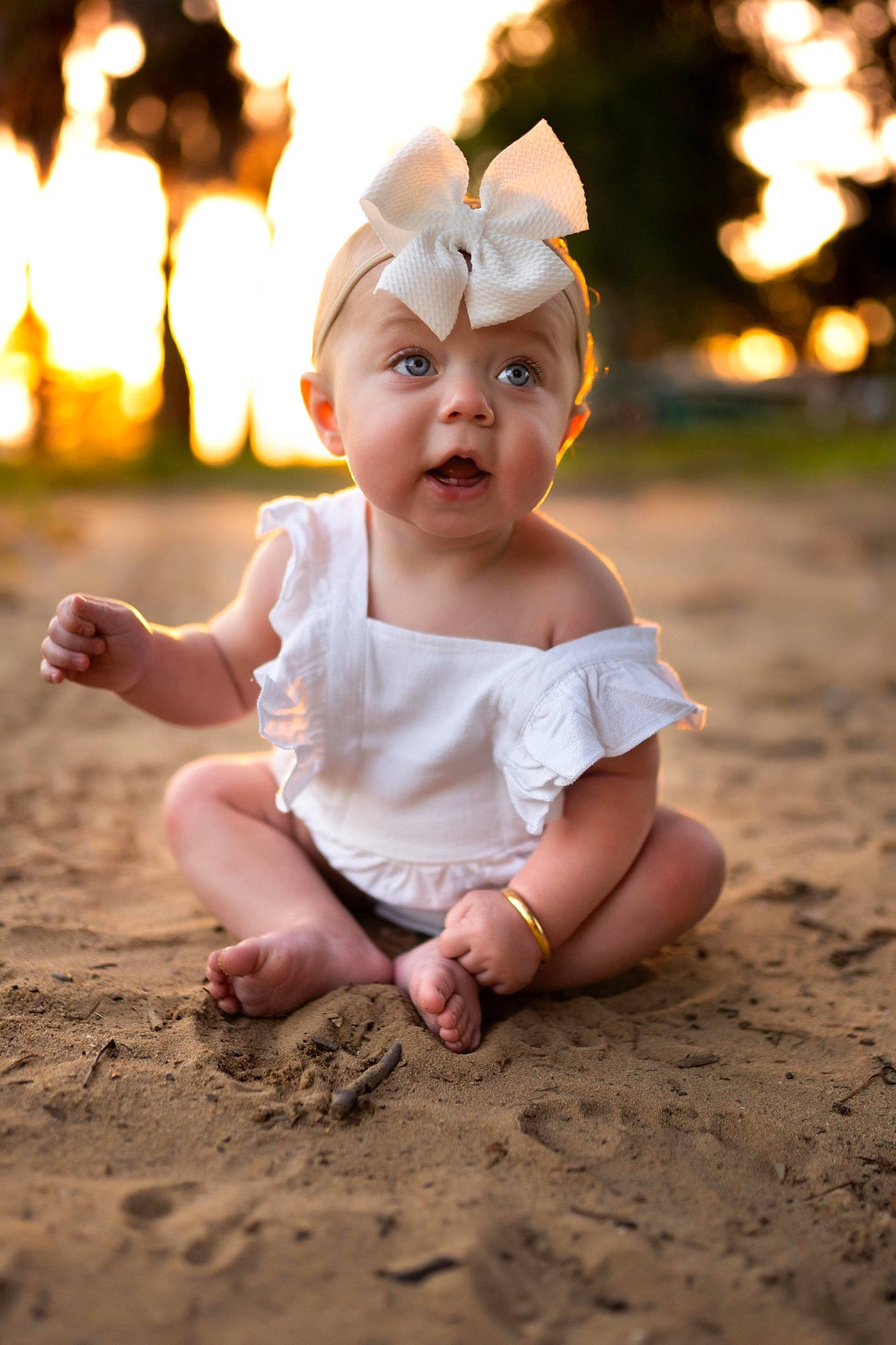 Whitley is registered to the contest to win money with this photo: baby, baby_toddler_clothing, beauty, child, finger, flash_photography, fun, gesture, grass, happy, headwear, human_leg, morning, people_in_nature, person, sand, sitting, sky, standing, summer