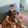 boy, brown_dog, child, companion, couch, dog, family, floppy_ears, home, hugging, indoor, pet, photography, pink_blanket, portrait, relaxed, sitting, sofa, white_chest, wooden_floor