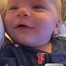 Weston is registered to the contest to win money with this photo: baby, smiling, face, pajamas, indoor, video_call, digital_screen, child, happy, person, portrait, closeup, cute, infant, blue_clothing, home, technology, screen_in_screen, communication, young