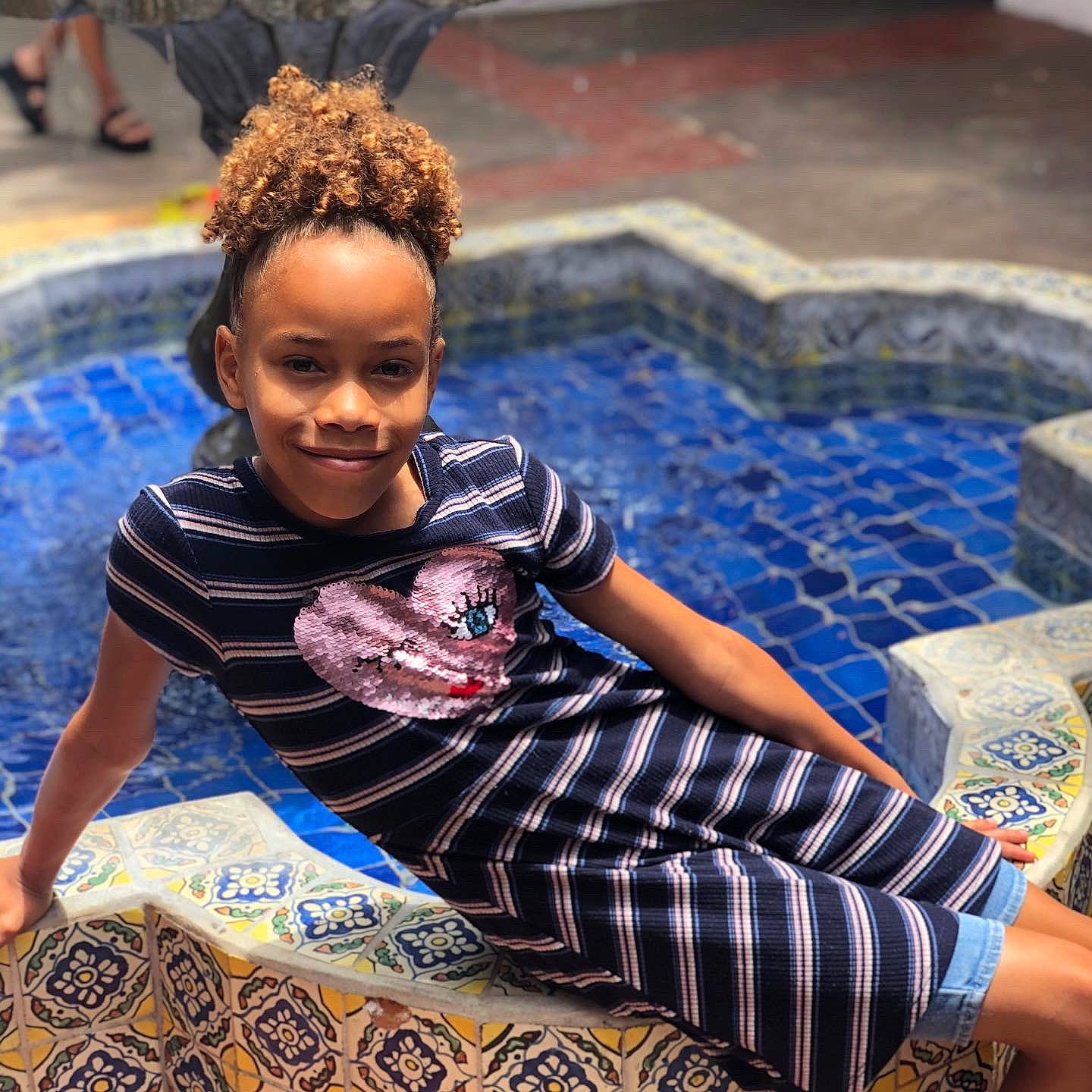 Alaysia joined the competition — help win amazing prizes! baby_toddler_clothing, child, dreadlocks, hair_accessory, human, joy, lap, leisure, linens, nightwear, pajamas, person, play, swimming_pool, tile, toddler, water_feature, world