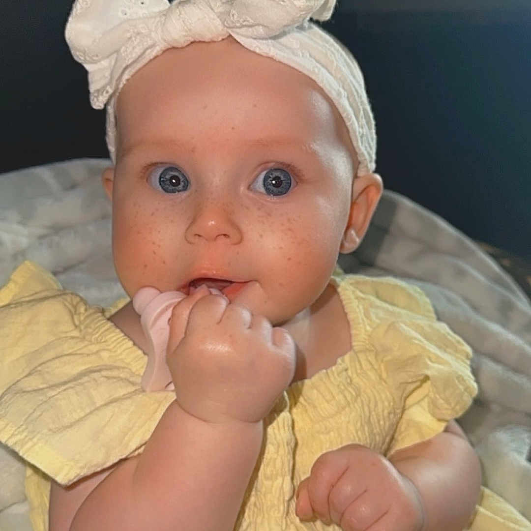 Lauren joined the competition — help win amazing prizes! accessories, baby, bodypart, bonnet, cap, clothing, dress, face, finger, hand, hat, head, headband, newborn, pants, person, photography, portrait, sitting, toy