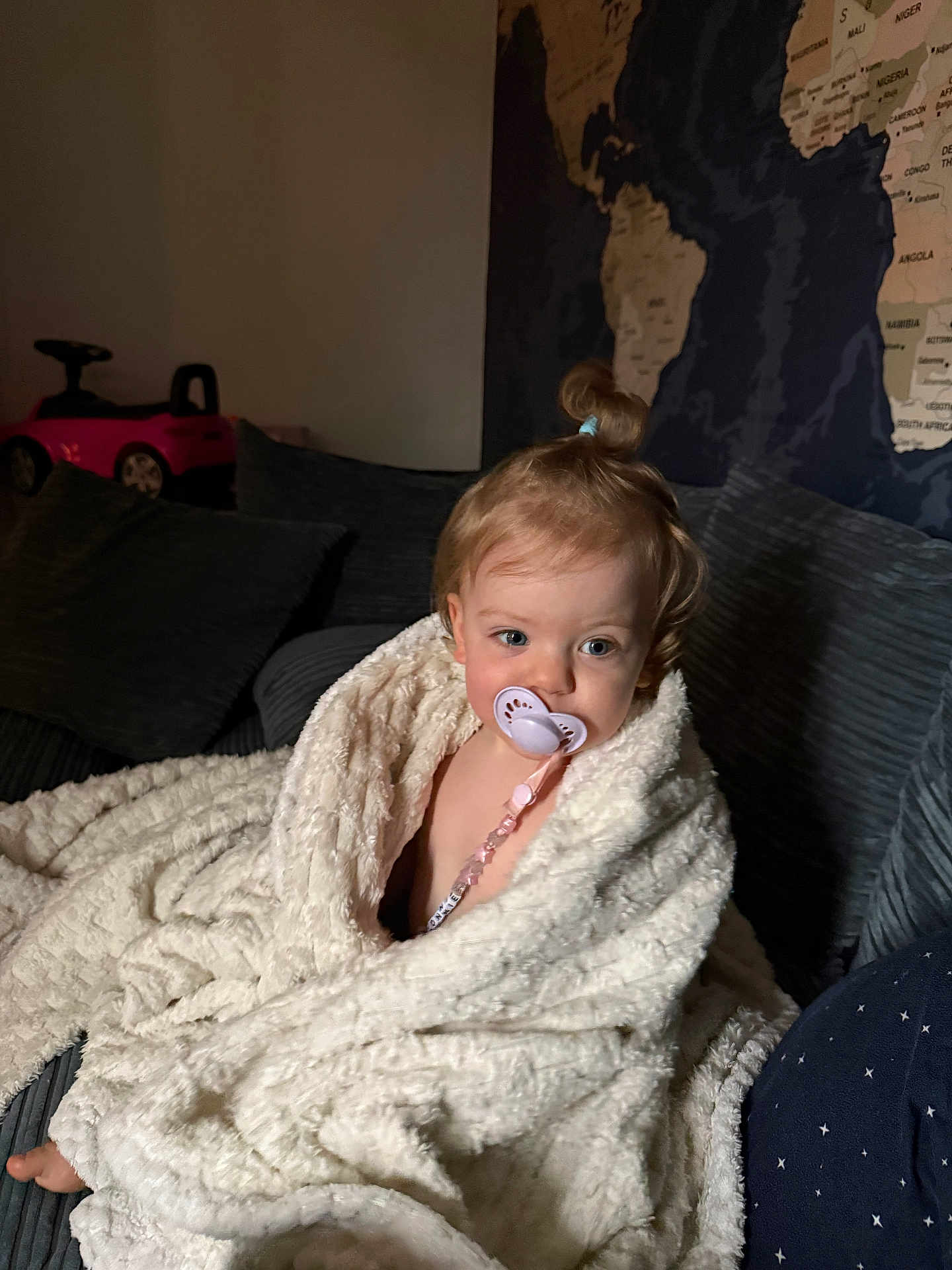 Connie joined the competition — help win amazing prizes! child, blanket, pacifier, couch, toy_car, hair_tie, indoor, map, cozy, child_with_pacifier, soft_texture, young_child, wrapped, seated, home_interior, curly_hair, plush_blanket, relaxed, small_child, baby