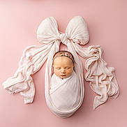 Luna joined the competition — help win amazing prizes! newborn, baby, sleeping, wrapped, cloth, pink_background, bow, headband, flower, soft_texture, portrait, studio, cute, peaceful, infant, child, tender, delicate, lying_down, adorable