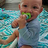 baby, child, infant, sitting, smiling, pacifier, blanket, bedroom, indoor, portrait, face, hands, barefoot, long_sleeves, toy, plush_toy, couch, furniture, home, happy