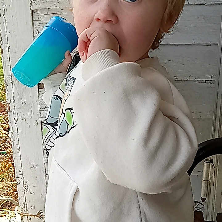 Andrew is registered to the contest to win money with this photo: baby, baby_products, baby_toddler_clothing, chair, cheek, chest, child, drinking, drinkware, face, fictional_character, gesture, happy, nose, plastic, plastic_bottle, play, toddler, toy