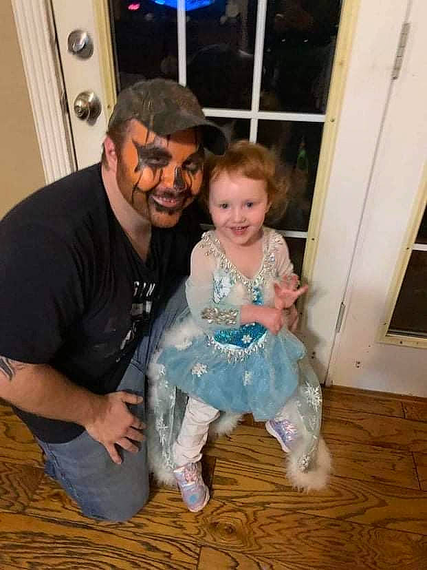 Hazel is registered to the contest to win money with this photo: baby_toddler_clothing, beard, child, cool, door, event, eyewear, flooring, fun, happy, hardwood, head, joy, leg, person, sitting, smile, standing, t_shirt, toddler