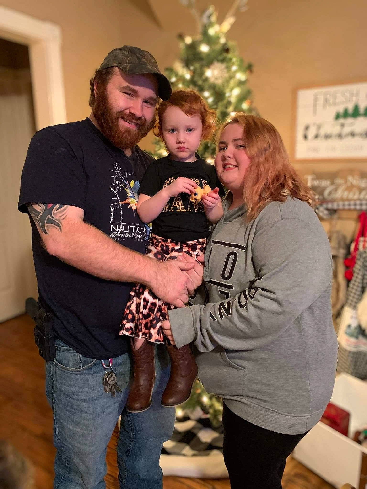 Hazel is registered to the contest to win money with this photo: beard, christmas, christmas_tree, event, facial_expression, fashion, fun, hair, hairstyle, happy, headwear, holiday, human, interaction, jewellery, joy, organ, person, sleeve, smile