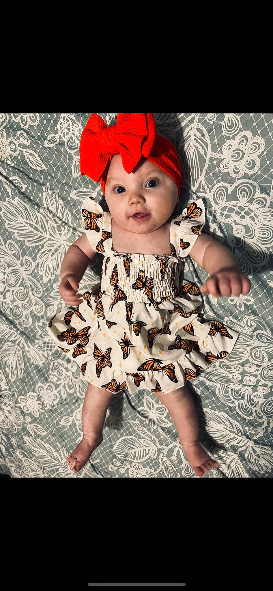 Maylee is registered to the contest to win money with this photo: baby, baby_toddler_clothing, day_dress, dress, eye, eyelash, face, fashion_design, fawn, flash_photography, happy, head, headgear, headpiece, headwear, one_piece_garment, pattern, person, petal, plant
