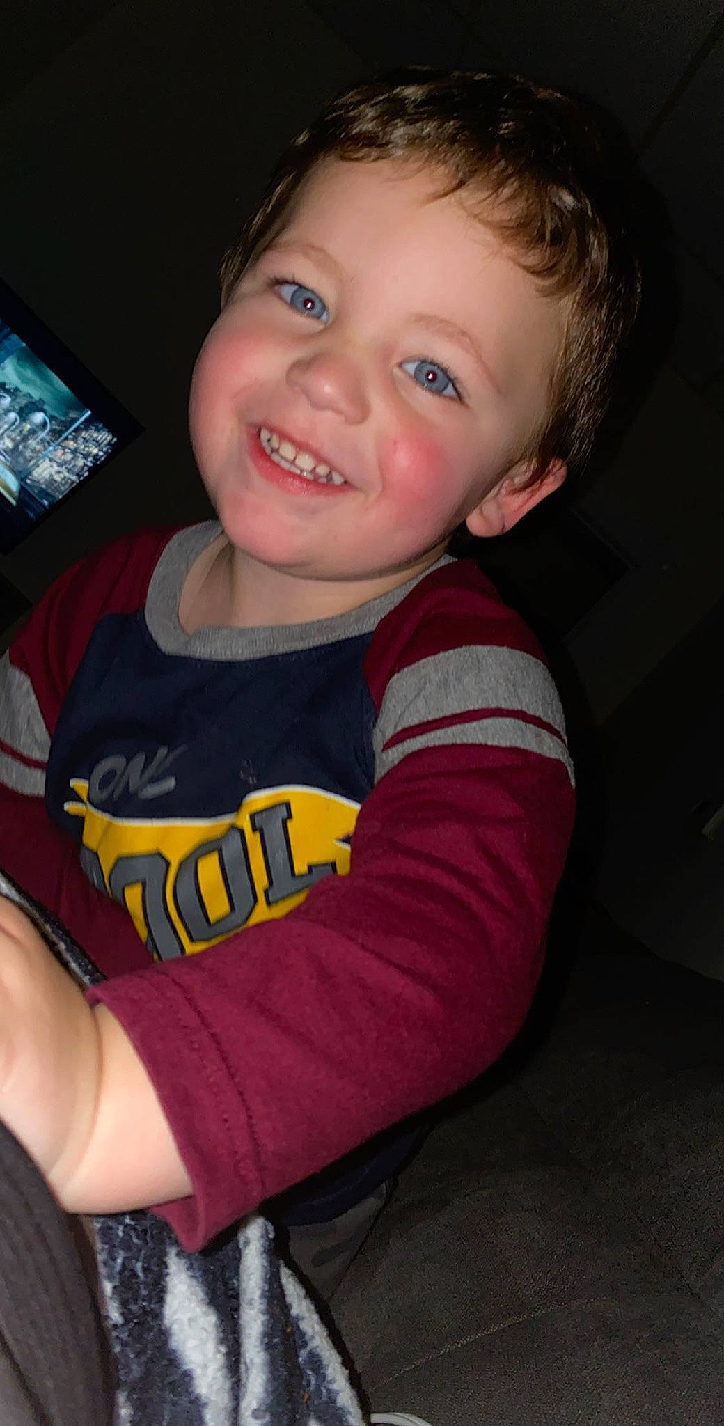 Josiah is registered to the contest to win money with this photo: baby, baby_toddler_clothing, cheek, child, communication_device, cool, display_device, ear, eye, facial_expression, flat_panel_display, iris, joy, laugh, lip, long_sleeved_t_shirt, mouth, person, portrait_photography, sleeve