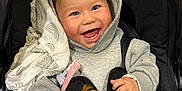 Mattias joined the competition — help win amazing prizes! baby, child, smiling, hoodie, stroller, plush_toy, giraffe, toy, happy, face, hands, clothing, blanket, indoor, cute, infant, person, portrait, comfort, warm