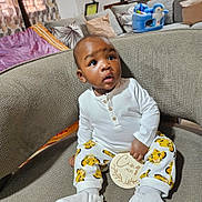 Hysaël Kenal participe au concours pour gagner de l'argent avec cette photo : baby, child, couch, cozy, curtains, cute, expression, furniture, home, indoors, infant, milestone, patterned_pants, penguin_toy, pillow, plush_toy, seated, sofa, white_shirt, wooden_plaque