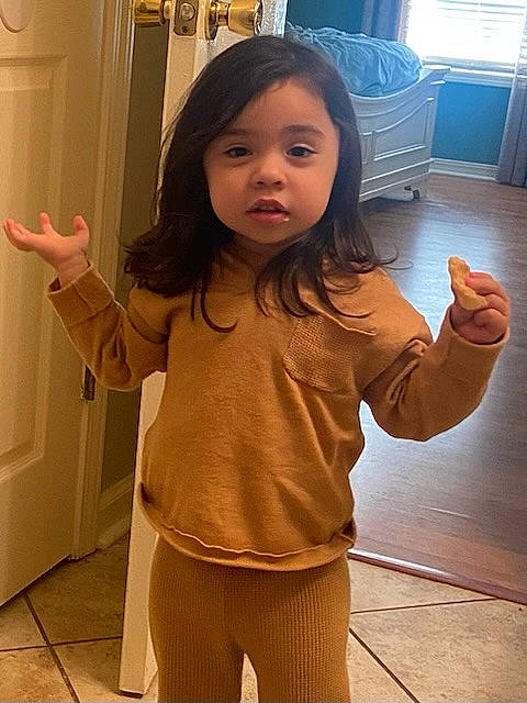 Teagen is registered to the contest to win money with this photo: eye, face, finger, floor, flooring, gesture, hair, hairstyle, hand, happy, head, joint, neck, organ, person, shoulder, skin, sleeve, standing, thumb