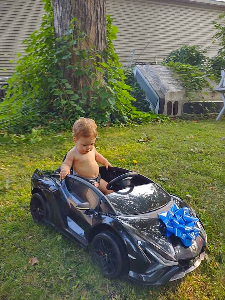 Draco joined the competition — help win amazing prizes! automotive_design, automotive_exterior, automotive_tire, automotive_wheel_system, bumper, car, grass, hood, lawn, leisure, motor_vehicle, person, personal_luxury_car, plant, tire, toddler, tree, vehicle, vehicle_door, wheel