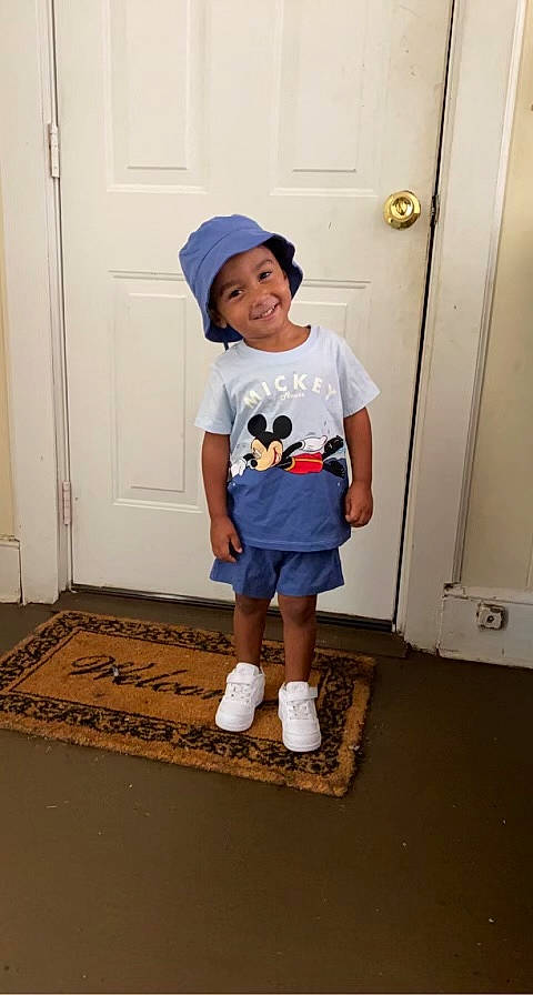 Derrick is registered to the contest to win money with this photo: arm, baby_toddler_clothing, cap, door, face, floor, flooring, footwear, hat, headwear, joy, knee, leg, person, shoe, shorts, sleeve, smile, sportswear, street_fashion