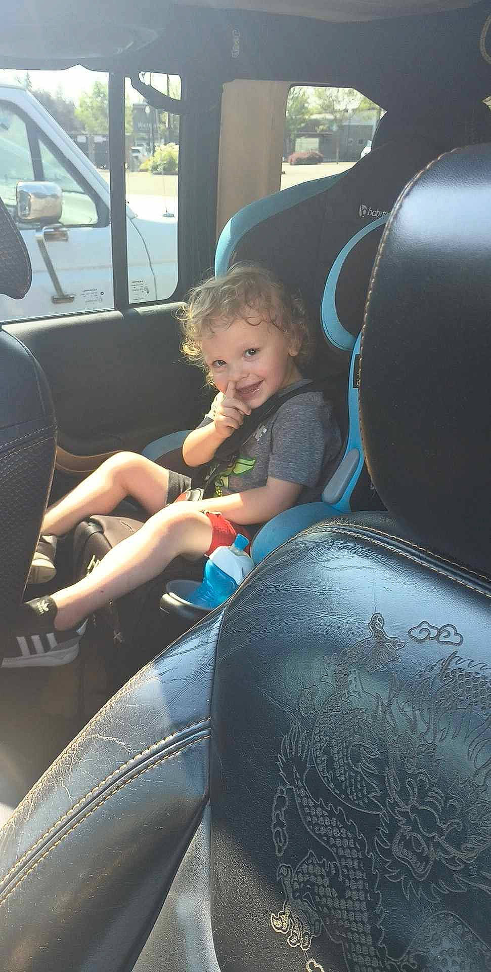 Gavin is registered to the contest to win money with this photo: auto_part, automotive_design, automotive_exterior, automotive_tire, car, car_seat, car_seat_cover, comfort, family_car, head_restraint, joy, motor_vehicle, person, personal_luxury_car, plant, sitting, steering_part, steering_wheel, toddler, vehicle