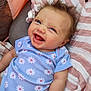 baby, child, smiling, laughing, blue_onesie, daisies, hair, blanket, striped, pink, white, face, happy, infant, cute, lying_down, skin, person, closeup, portrait