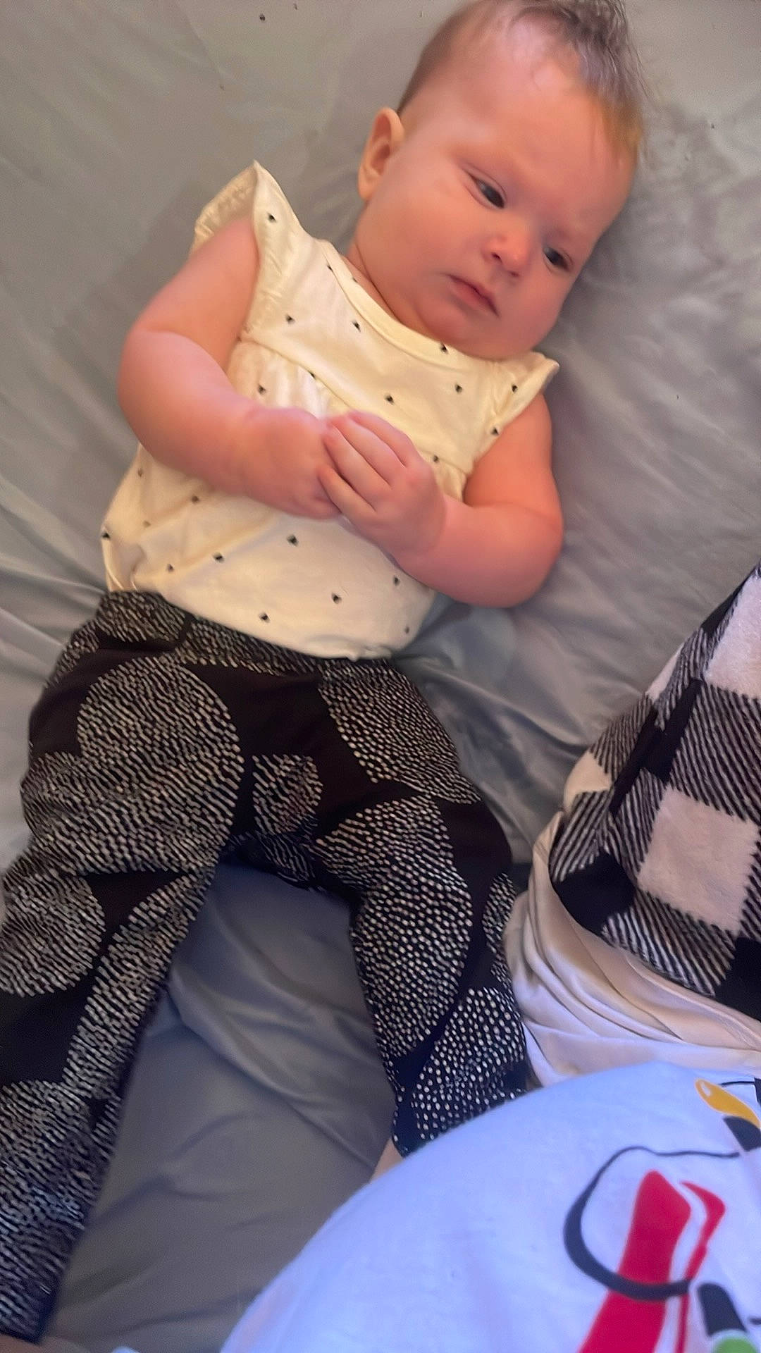 Katie is registered to the contest to win money with this photo: abdomen, baby, baby_toddler_clothing, chest, child, comfort, elbow, human_body, human_leg, knee, lap, linens, pattern, person, sitting, sleeve, textile, thigh, toddler, trunk