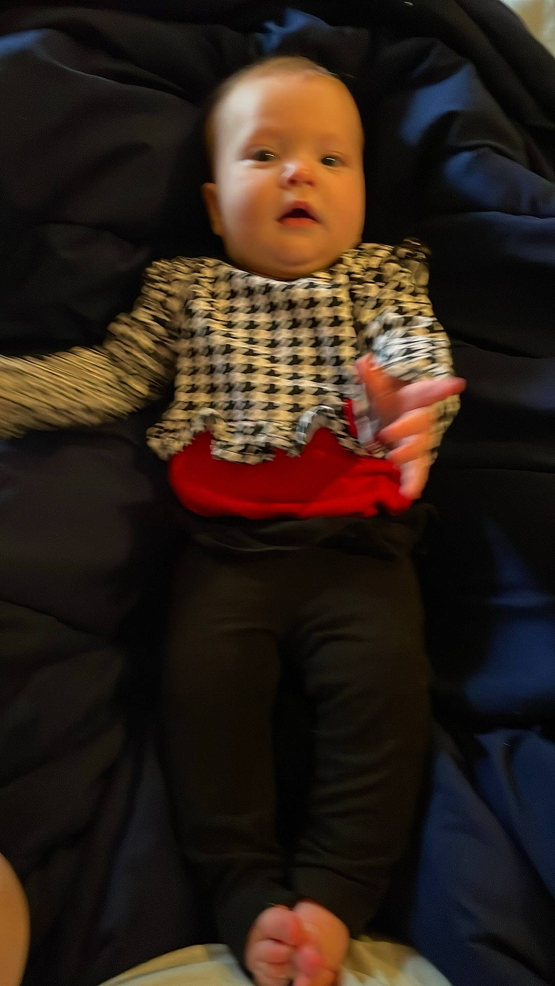 Katie is registered to the contest to win money with this photo: abdomen, baby, baby_toddler_clothing, cheek, child, comfort, event, eye, face, facial_expression, flooring, fun, gesture, happy, lap, mouth, outerwear, person, sitting, sleeve