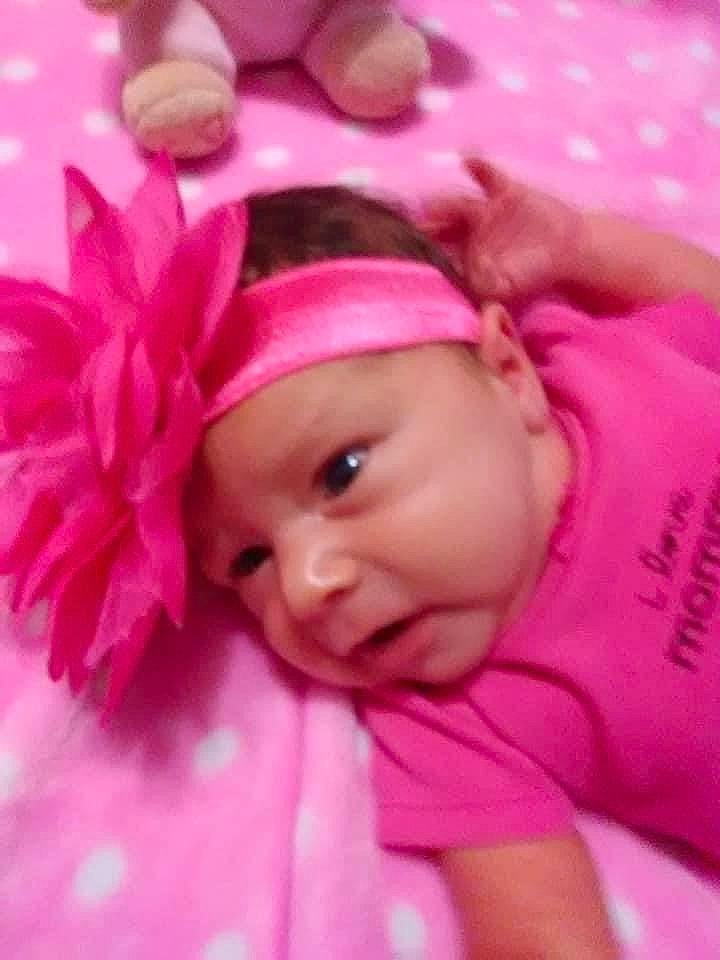 Ava is registered to the contest to win money with this photo: baby, baby_products, baby_sleeping, baby_toddler_clothing, cap, cheek, eye, eyebrow, eyelash, fashion_accessory, finger, happy, headband, headgear, headwear, lip, magenta, person, petal, pink