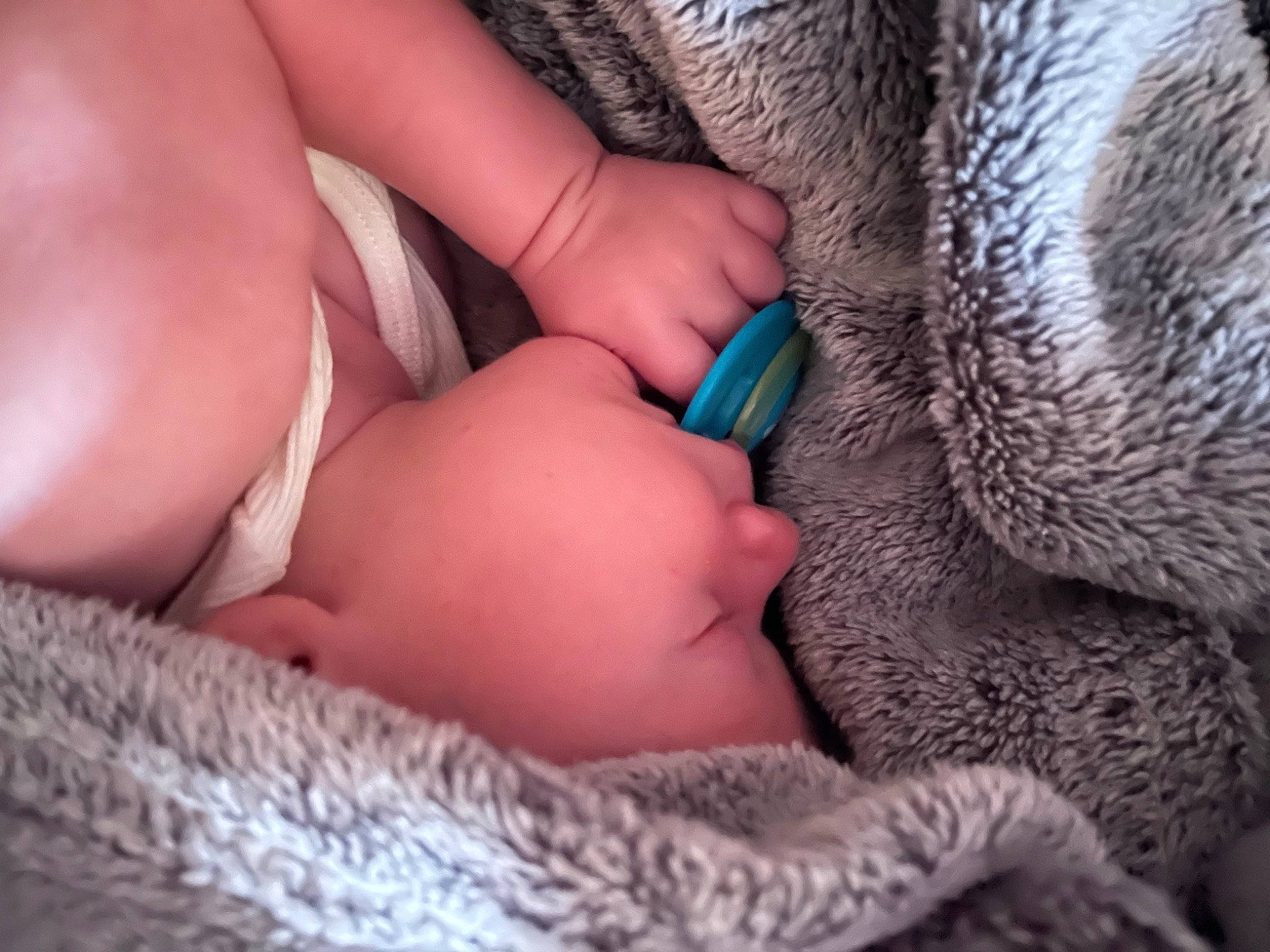 Layton is registered to the contest to win money with this photo: baby, child, comfort, eyelash, finger, gesture, hand, headwear, human_leg, leg, linens, mouth, nail, nose, pattern, person, skin, textile, thumb, toddler