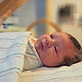 baby, newborn, blanket, striped, face, infant, sleepy, resting, indoors, nursery, soft_light, portrait, closeup, head, person, cozy, child, lying_down, cute, wrapped